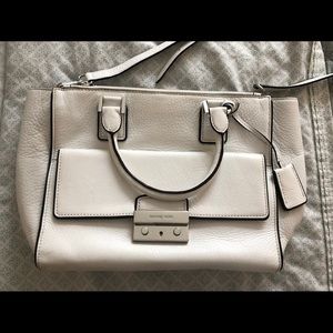 White Michael Kors purse.